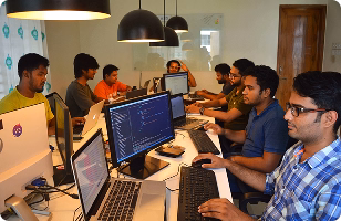 Team of software engineers at Jouleslabs writing clean code for production-grade SaaS applications in a collaborative workspace.
