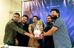 Jouleslabs team celebrating 8+ years of excellence, presenting an appreciation gift to CEO Arifur Rahman Naim and CTO Nahid Bin Azhar for leading production-grade SaaS and AI development services.