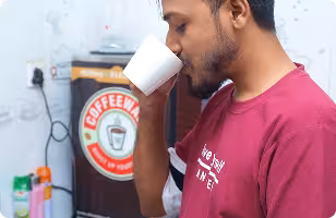 A developer at Jouleslabs taking a coffee break, highlighting the vibrant work culture behind their production-grade SaaS and AI development services.